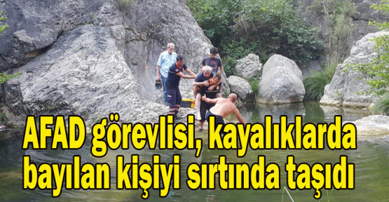 AFAD görevlisi, kayalıklarda bayılan kişiyi sırtında taşıdı